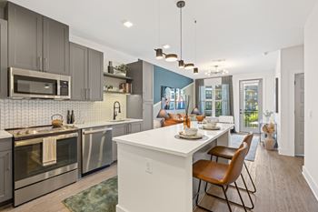 Shaker-style gray cabinetry with gold hardware (b)
